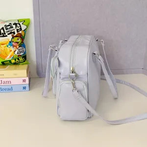 Detailed view of the Japanese style purple ita bag featuring multiple exterior pockets and zippers.