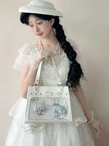 Detail view of the white transparent ita bag featuring cute anime badges, lace bow and chic design.