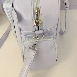 Close-up detail of a light purple Japanese style commuter shoulder bag zipper and hardware.