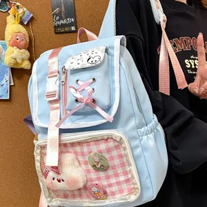 Zaino Ita azzurro chiaro kawaii con finestra trasparente, simpatici fiocchi e ciondoli in peluche.