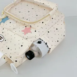 Detail view of cute beige star print ita backpack with clear window and side pocket.