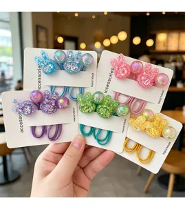 Detailed close-up view of colorful resin rabbit hair ties with elastic bands on cards.