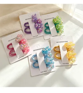Detailed view of colorful glitter bunny hair ties for kids, high elasticity rubber bands.