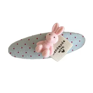 Korean fabric oval hair clip with a cute pink plush bunny and sweet red polka dot design.