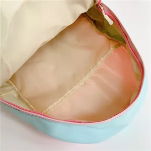 Interior detail view of a cute pastel ita backpack featuring pink and blue color blocking.