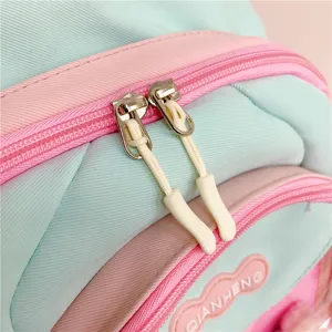 Cute pastel backpack detail showing durable double zippers and soft fabric design for daily wear.
