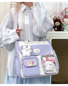 Vintage color-block canvas shoulder bag with clear front pocket and cute plush pendants for girls.