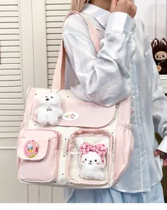 Cute canvas shoulder bag with plush bunny and dog charms, pink and white design for girls.