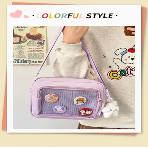 Detail view of a purple Japanese ins style ita bag with clear pocket, badges and plush pendant.