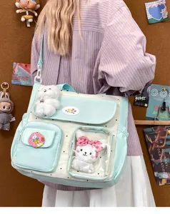 Retro color-blocking large canvas tote shoulder bag with cute plush charms detail view.