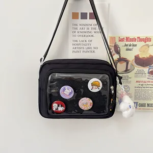 Black canvas crossbody ita bag with clear window, cute pins and plush charm for students daily use