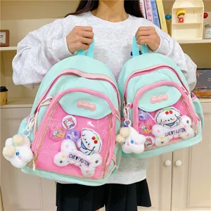 Clear detail shot of mint green ita backpack with pink mesh pocket, cute plush doll charm.