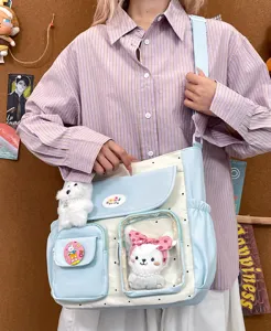 Cute sweet style canvas messenger bag with large capacity, clear pocket, and charming plush toys.