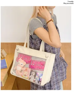 Cute transparent ita bag detail showing clear window pocket, pins, and custom anime merchandise inserts.