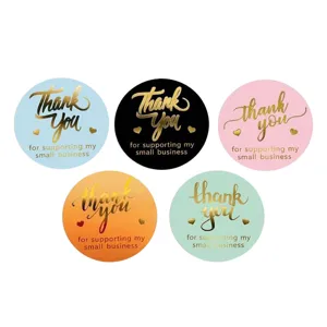 Detailed close-up view of colorful round thank you stickers featuring shiny gold foil text.