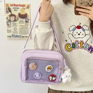 Close-up detail of a light purple ita bag with transparent mesh pocket and cute pins.