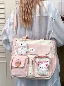 Detail view of retro color block canvas tote bag with cute plush charms for daily school commuting.