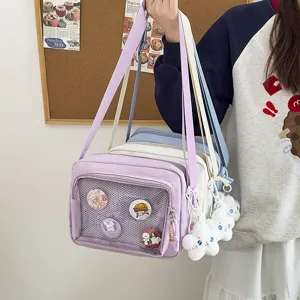 Japanese style itabag crossbody bag detail showing mesh pocket, cute pins and plush pendants.
