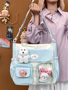 Retro color-blocking canvas shoulder bag with cute plush pendants and multiple pockets.