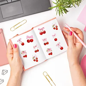 Cherry bow sticker detail view, cute cartoon aesthetic decorative tape for journaling crafts.