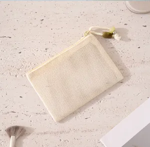 Close-up detail of a portable beige mesh zipper pouch with beaded lanyard, ideal for tiny items.