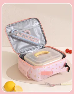 Interior detail of pink daisy rainbow insulated lunch bag with mesh pocket and spacious bento storage.