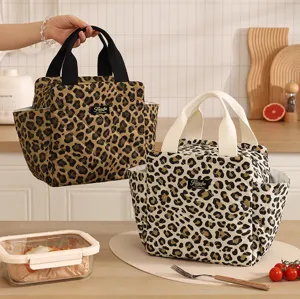 Quilted leopard print lunch bag with sturdy handles, side pockets, and stylish design detail.