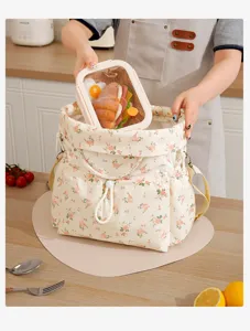 Floral insulated lunch bag with drawstring closure, stylish portable bento tote for daily commuting.