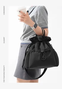 Detail shot of the black drawstring commuter tote bag, showcasing daily use and elegant style.