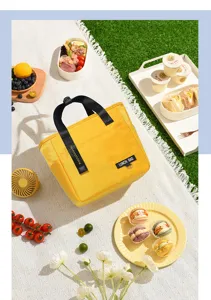 Portable yellow insulated lunch bag for work and school, stylish thermal tote food container.