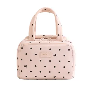 Pink polka dot lunch bag with bows, insulated tote bag for work and school use main view.