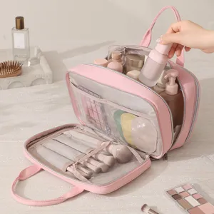Pink multi-layer portable travel cosmetic bag with large capacity and multi-compartment design.