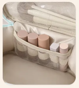 Close-up detail of cosmetic bag interior with mesh pockets and organized compartments