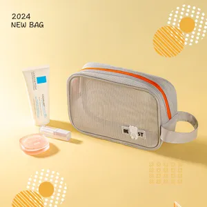 Portable mesh toiletry bag with orange zipper, large capacity travel cosmetic storage pouch.