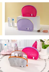 Detailed view of portable half-round mesh cosmetic bag, ideal for travel and beach use.