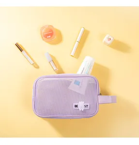 Portable purple mesh cosmetic bag with handle, large capacity travel toiletry organizer for women.