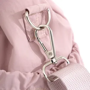 Pink commuter bag metal hardware detail shot, durable strap and clasp for daily use.