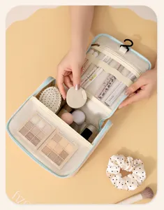 Portable hanging toiletry bag with multiple mesh compartments and large capacity for travel.
