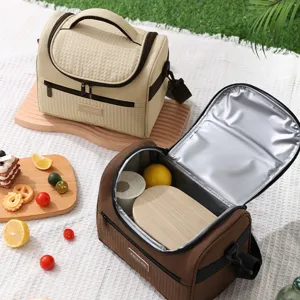 Portable insulated lunch bag with shoulder strap, stylish cooler bag for work and school.