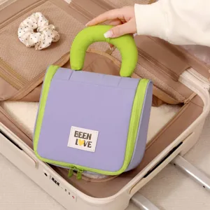 Portable travel toiletry bag with hanging handle and large capacity purple cosmetic organizer.