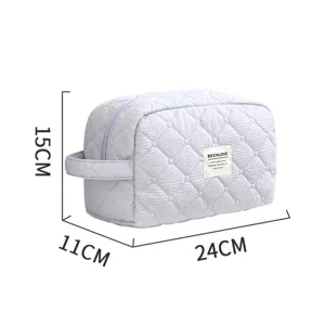 Quilted cosmetic bag with side handle, portable travel makeup pouch in light purple lavender.