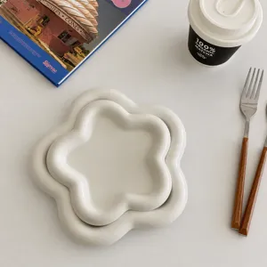 Minimalist white ceramic flower shaped breakfast plate, elegant dessert and salad dish.