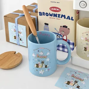 Detailed view of blue ceramic mug with cute puppy illustration, wooden spoon and lid.
