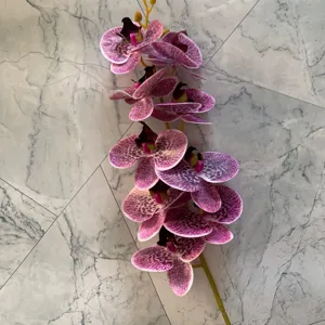 Closeup detail view of 9-head artificial phalaenopsis orchid branch with purple spotted petals