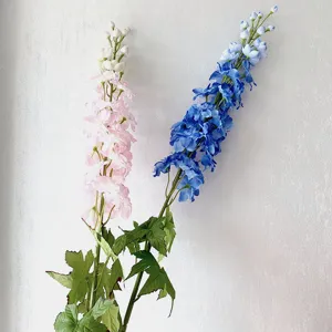 Artificial delphinium long branch fake flower detail view for wedding arch and home decor setup.