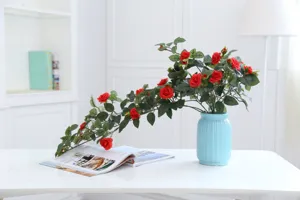 Exquisite artificial red rose bouquet in light blue vase, perfect home decor detail shot.