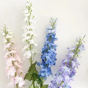 Artificial delphinium flower detail view, colorful long stem floral decor for wedding and home.