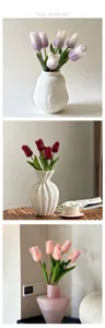 Detailed view of artificial tulip flower bouquets in various elegant ceramic and glass vases.