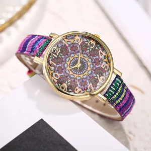 Boho style vintage watch detail, colorful woven canvas strap and mandala dial close-up.