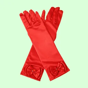 Red satin gloves detail view featuring cute bow and gem for kids dress up performance.